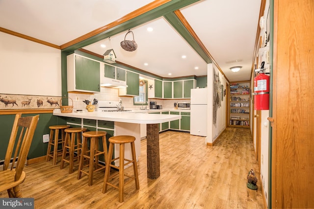 kitchen featuring kitchen peninsula, light wood-type flooring, white appliances, crown molding, and sink