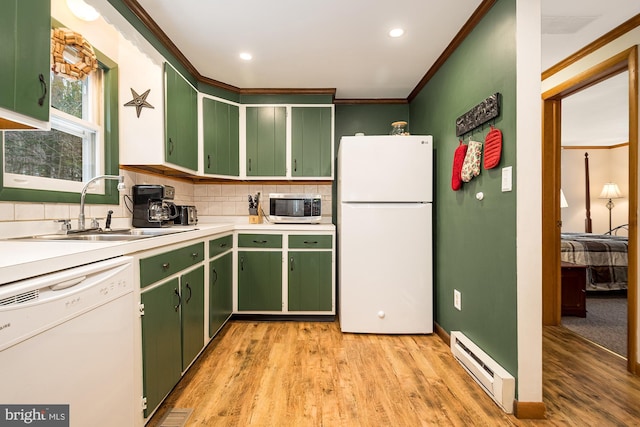 kitchen with light wood-type flooring, white appliances, baseboard heating, and sink