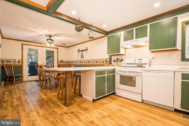 kitchen featuring white appliances, light hardwood / wood-style floors, green cabinetry, and crown molding