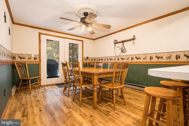 dining room with light hardwood / wood-style floors, ceiling fan, and ornamental molding