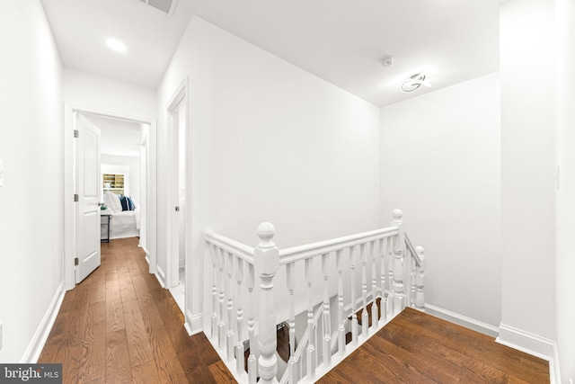 hallway with hardwood / wood-style floors