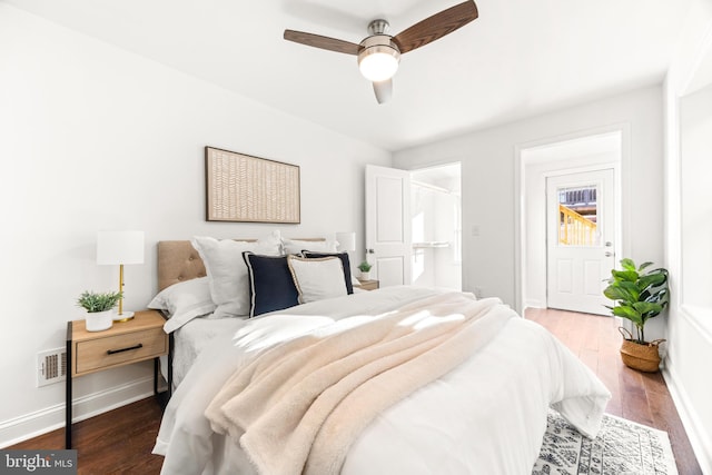 bedroom featuring hardwood / wood-style floors, ensuite bathroom, and ceiling fan