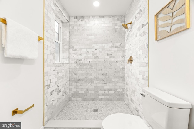 bathroom featuring toilet and tiled shower