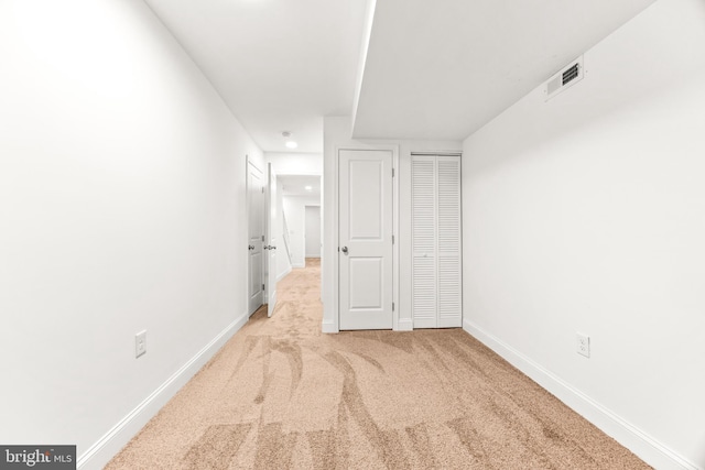 interior space featuring light carpet