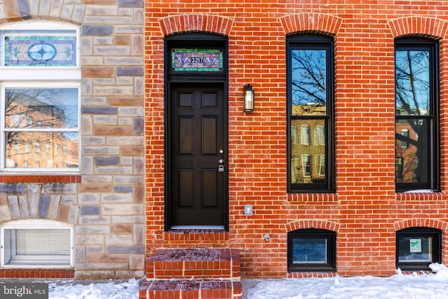 view of snow covered property entrance