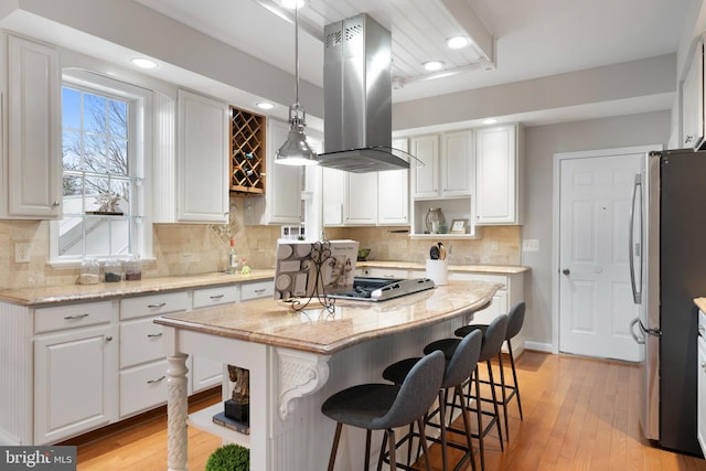 kitchen featuring white cabinetry, island range hood, appliances with stainless steel finishes, and open shelves