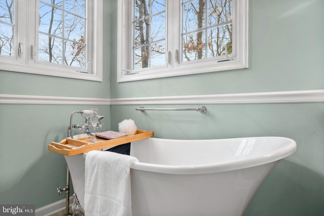 full bath featuring a soaking tub