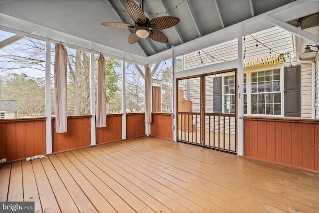 unfurnished sunroom with lofted ceiling and a ceiling fan