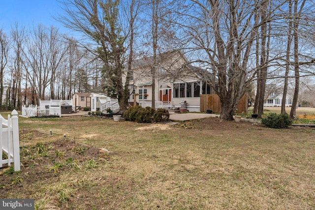 view of yard featuring a sunroom and fence