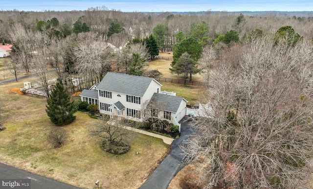 bird's eye view with a wooded view