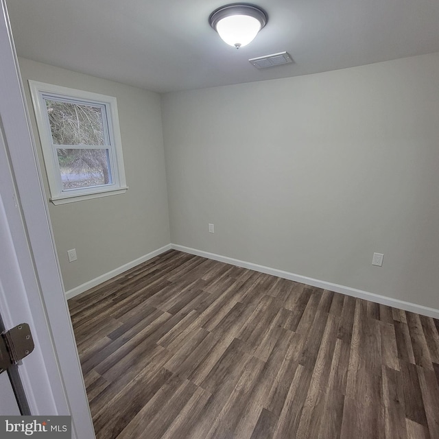 unfurnished room featuring dark hardwood / wood-style floors