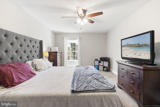 bedroom with ceiling fan and light carpet