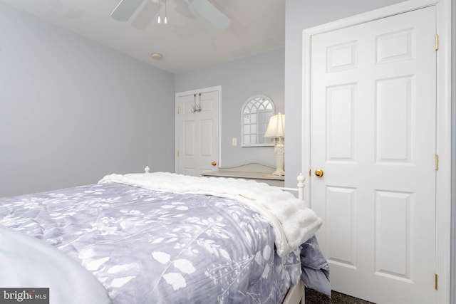 bedroom featuring ceiling fan and carpet