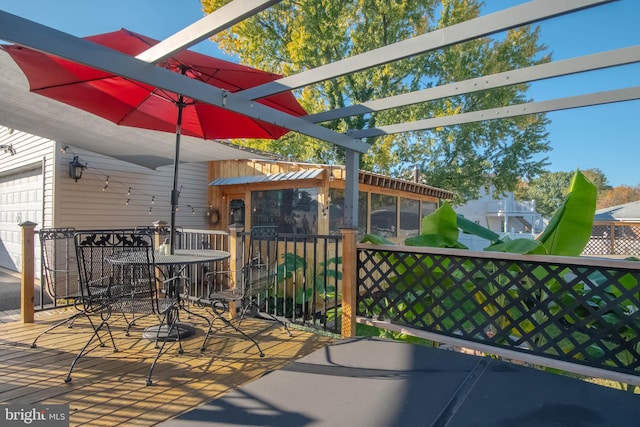 view of patio / terrace with a pergola and a garage