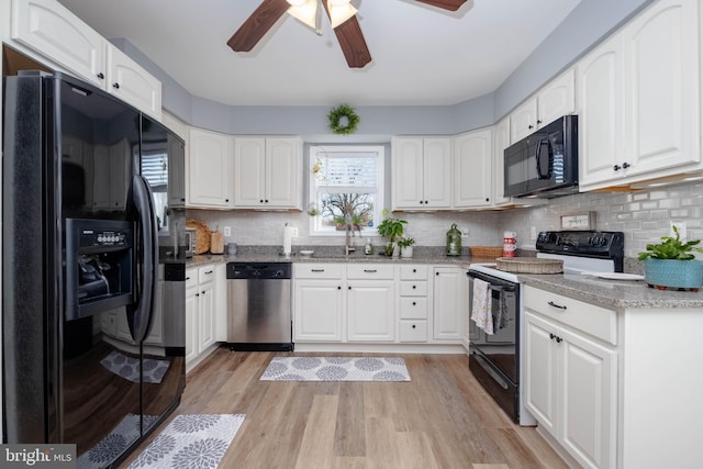 kitchen featuring black appliances, white cabinets, and light wood-type flooring