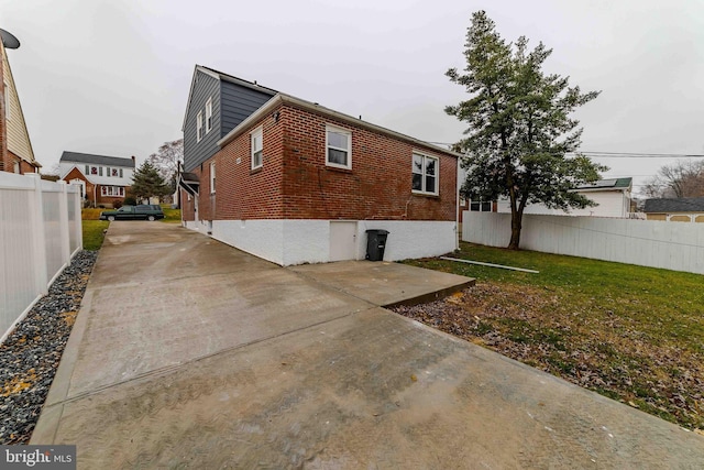 view of side of property with a lawn