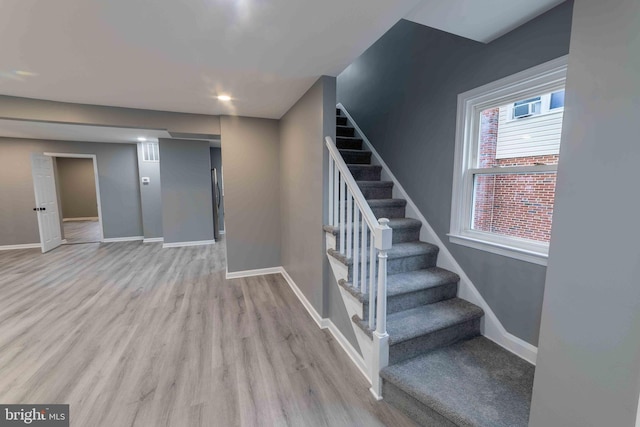 stairs featuring hardwood / wood-style flooring