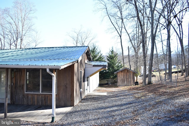 view of property exterior with a storage shed