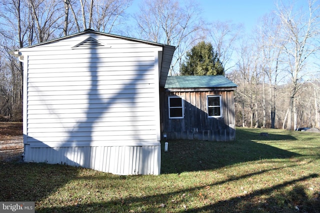 view of home's exterior with a yard