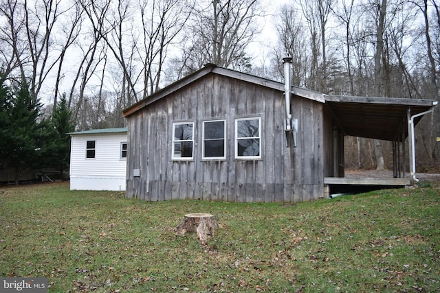 view of side of property with a lawn