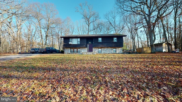 view of front facade with entry steps and stone siding