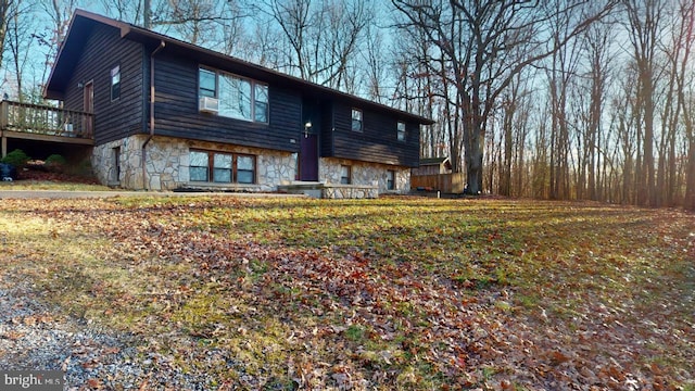 exterior space with stone siding and a wooden deck