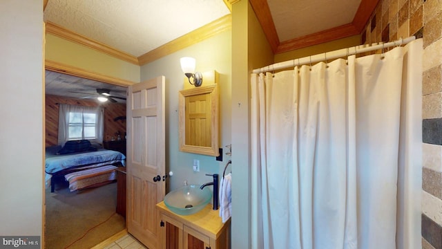 bathroom featuring walk in shower, ornamental molding, ceiling fan, sink, and tile patterned flooring