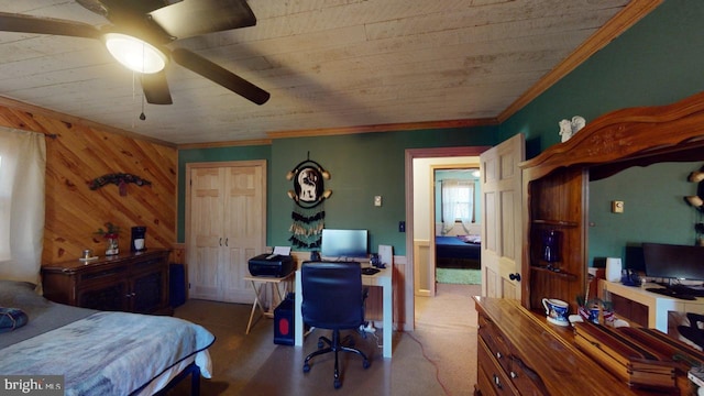 bedroom with ceiling fan, ornamental molding, and wooden walls