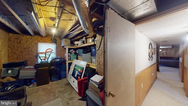 basement featuring wood walls