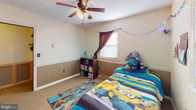 bedroom with ceiling fan, carpet floors, and a baseboard heating unit