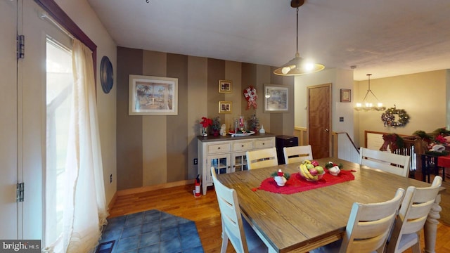 dining space with a chandelier and light hardwood / wood-style floors