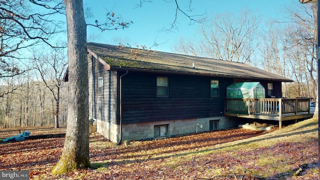 view of side of property featuring a deck