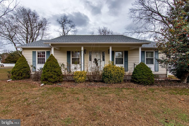 view of front facade with a front lawn and covered porch