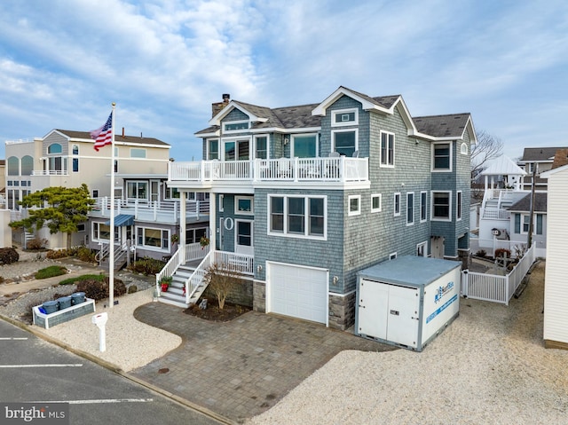 view of front of house featuring a balcony and a garage