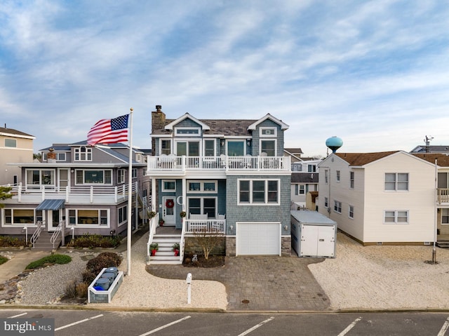 multi unit property featuring a garage and a balcony