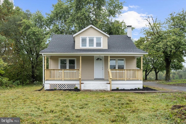 bungalow-style house featuring a porch and a front yard