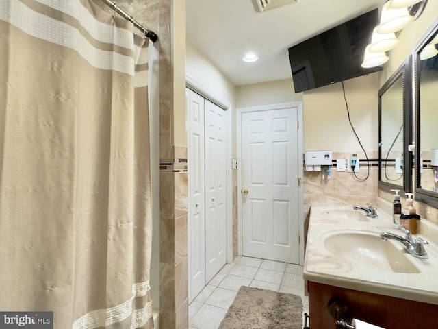 bathroom with tile patterned flooring, vanity, and curtained shower