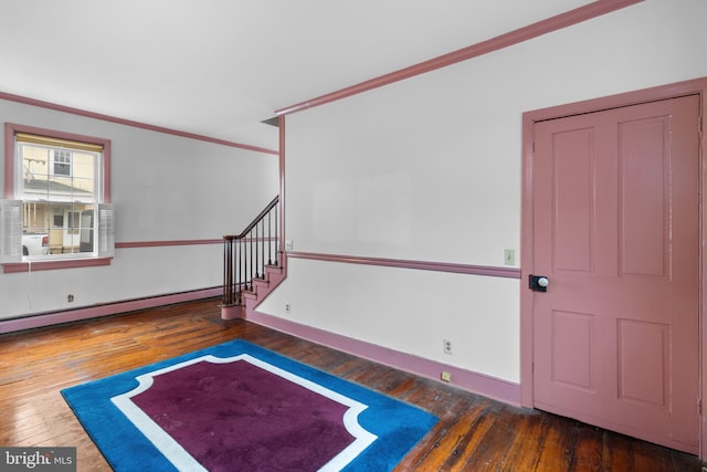 foyer with dark hardwood / wood-style floors, crown molding, and a baseboard heating unit