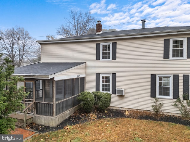 back of house featuring a wall mounted AC and a sunroom