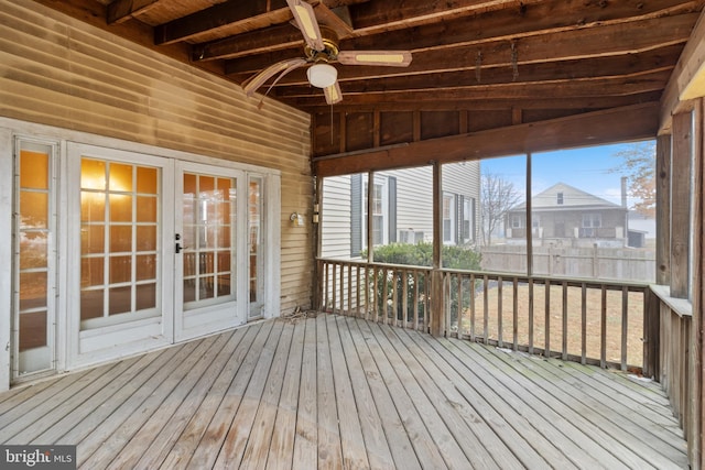 unfurnished sunroom featuring vaulted ceiling with beams and ceiling fan