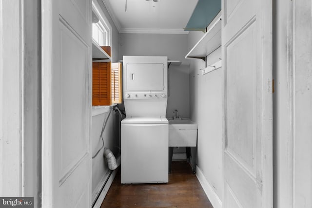 clothes washing area featuring crown molding, dark wood-type flooring, and stacked washer and clothes dryer