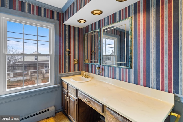 bathroom with baseboard heating and vanity