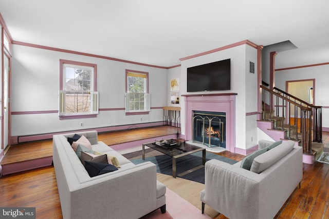 living room featuring ornamental molding, a baseboard heating unit, and hardwood / wood-style flooring