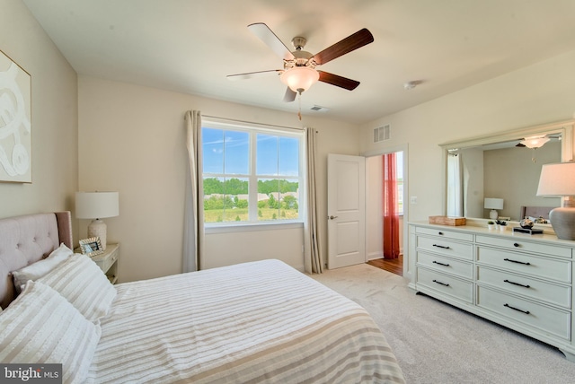 bedroom featuring light carpet and ceiling fan