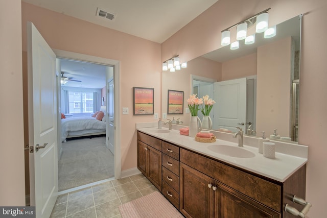 bathroom with ceiling fan, tile patterned flooring, and vanity