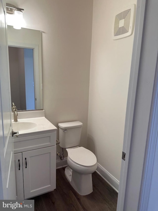 bathroom featuring hardwood / wood-style floors, vanity, and toilet