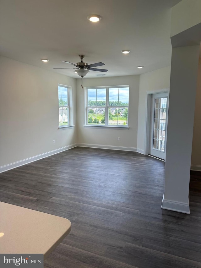 unfurnished room featuring dark hardwood / wood-style floors and ceiling fan