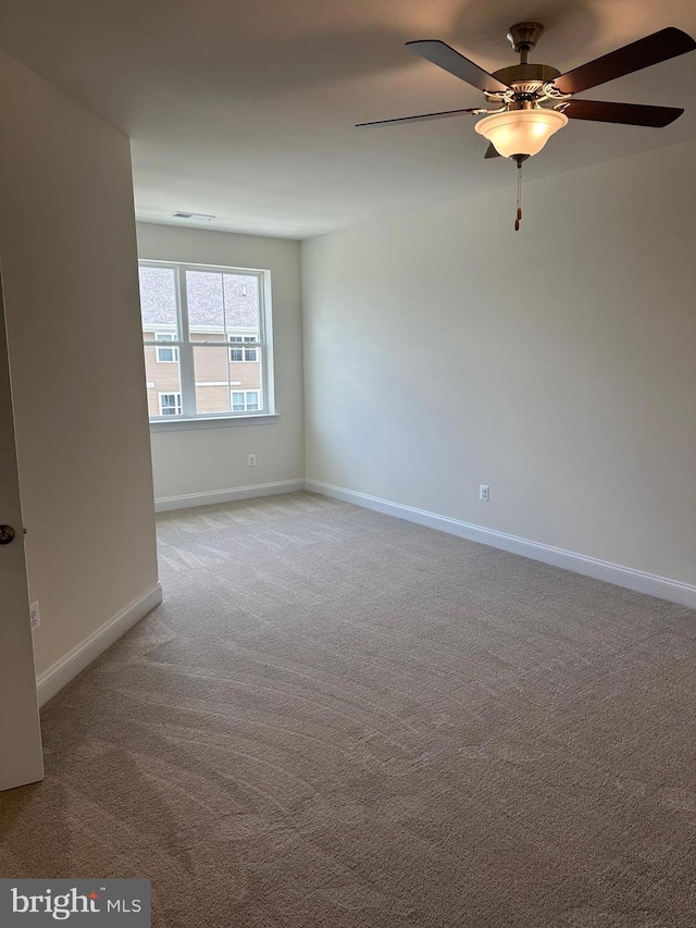 carpeted spare room with ceiling fan