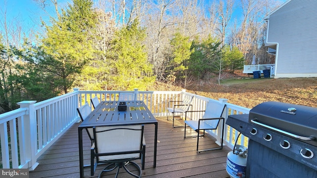 wooden deck with a grill