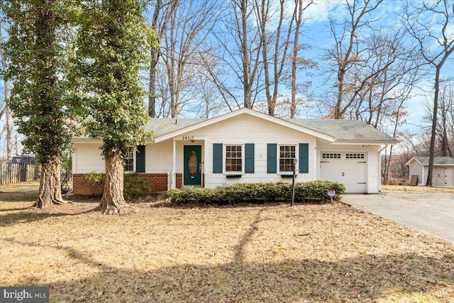 ranch-style home with driveway, a garage, fence, and brick siding